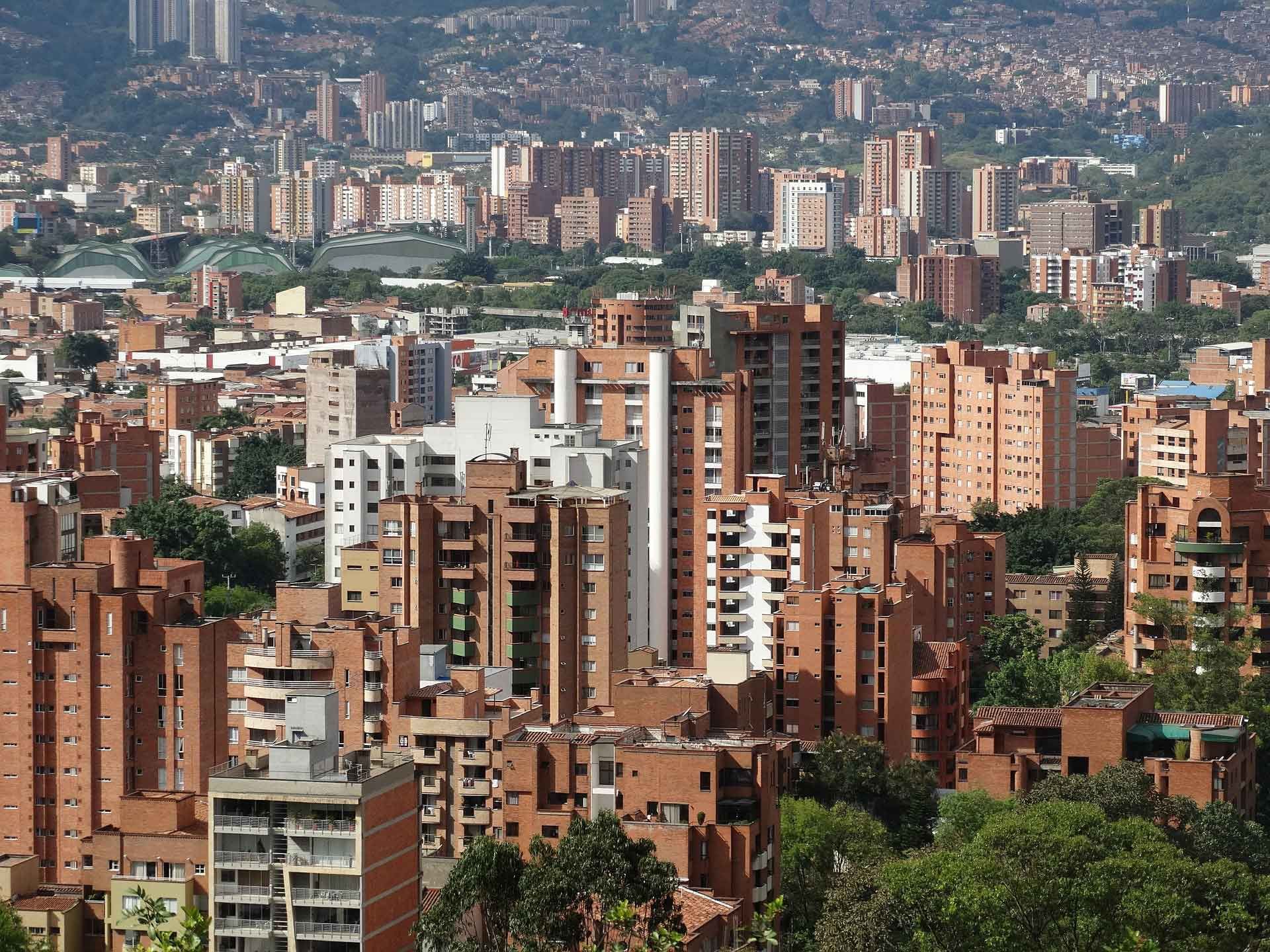 Densely packed city with many brick buildings under a clear sky.